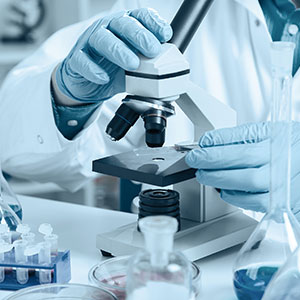 Scientist using microscope